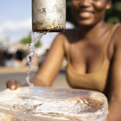 african-woman-pouring-water-recipient african-woman-pouring-water-recipient